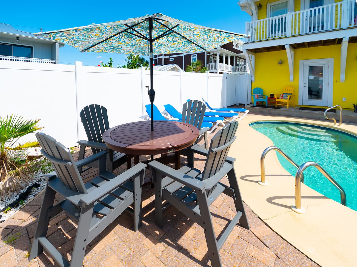 Poolside dining table and chairs beside the private pool